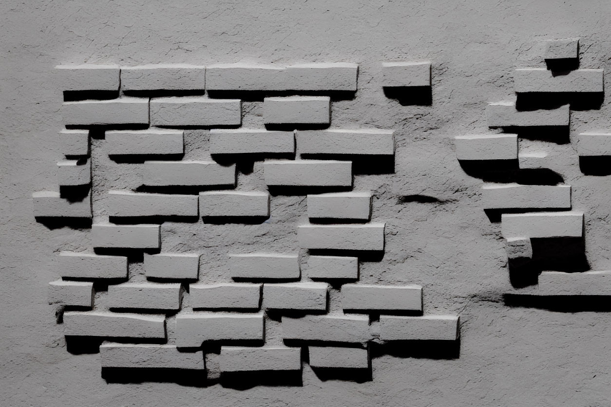 Sporadic white bricks on textured grey wall with shadows