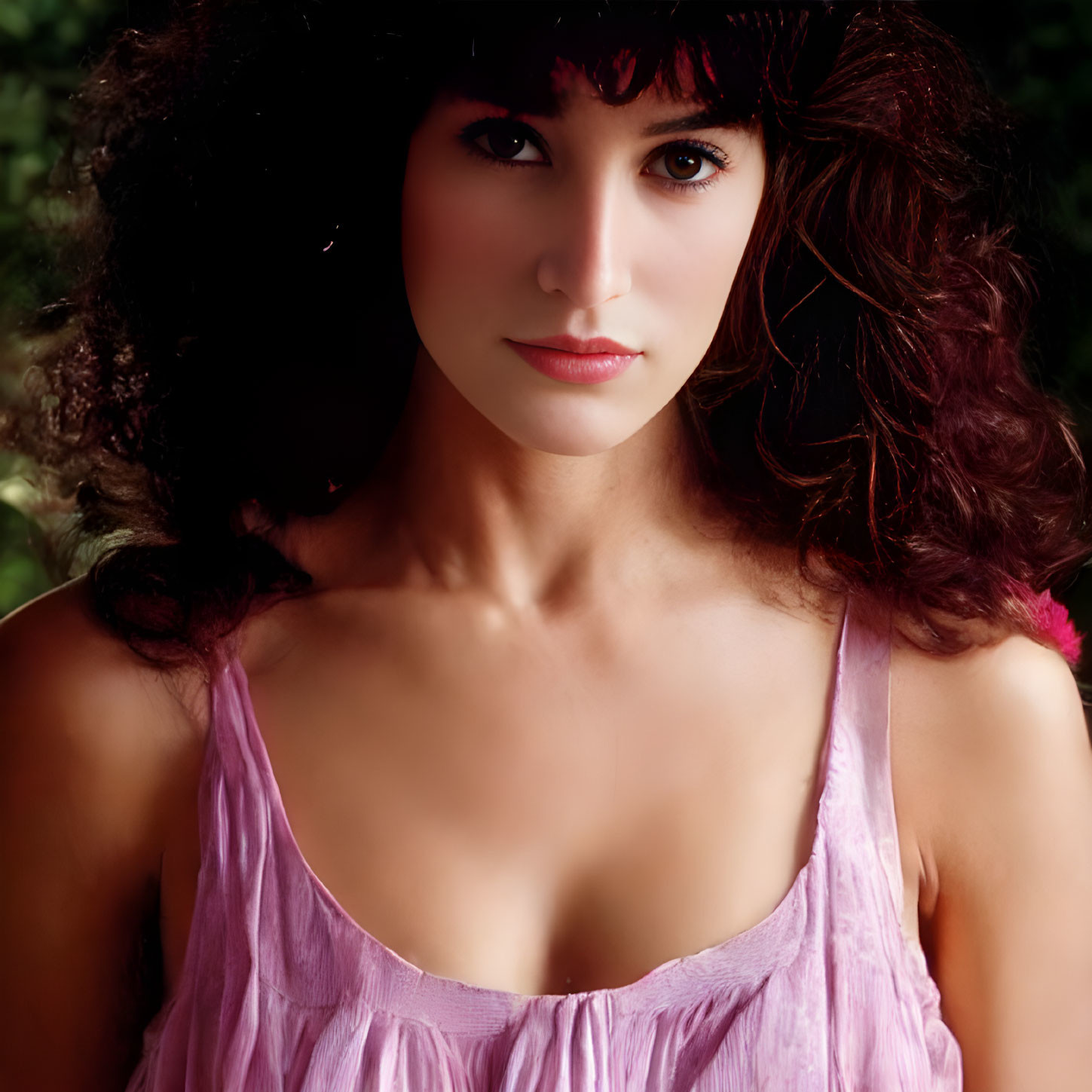 Portrait of Woman with Curly Dark Hair in Pink Top