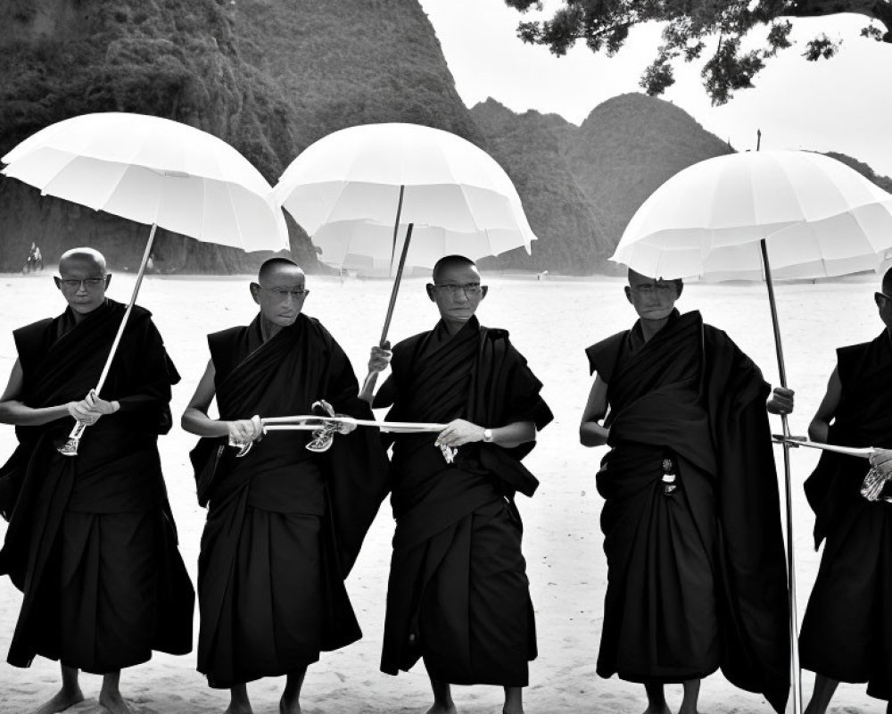 Traditional monks with white umbrellas on sandy beach with hills