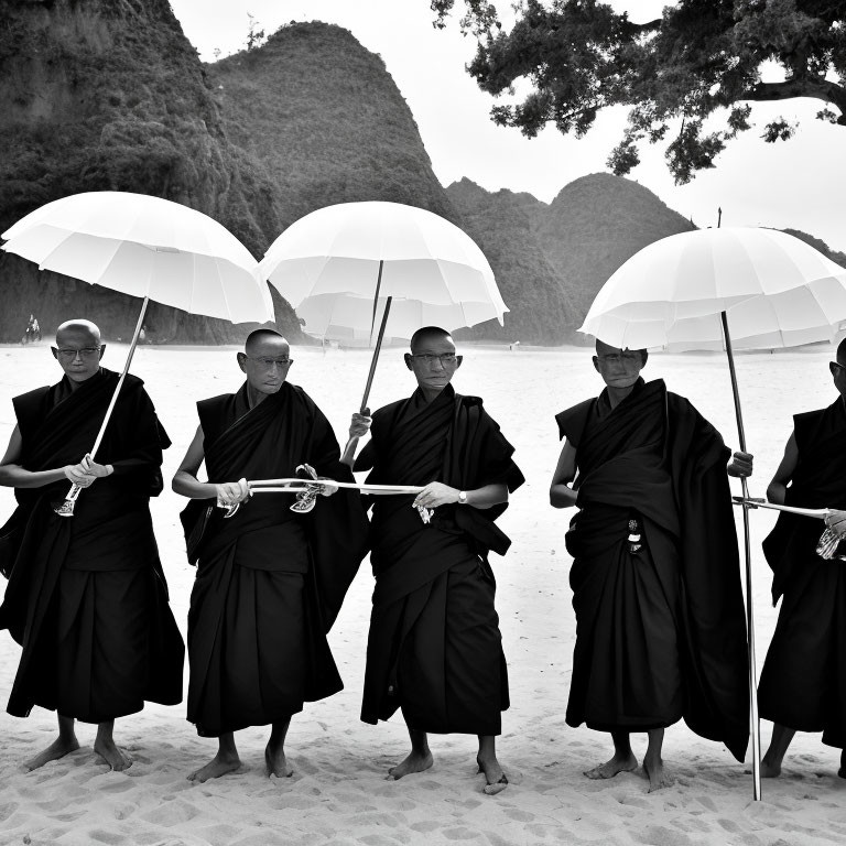 Traditional monks with white umbrellas on sandy beach with hills