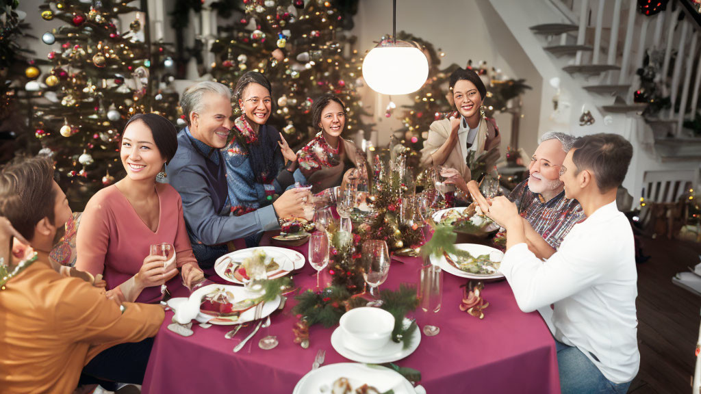 Group celebrating Christmas dinner at festive table with trees