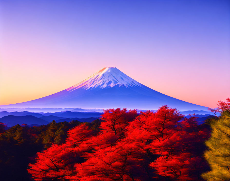 Snow-capped Mount Fuji against a colorful dawn sky and autumn trees