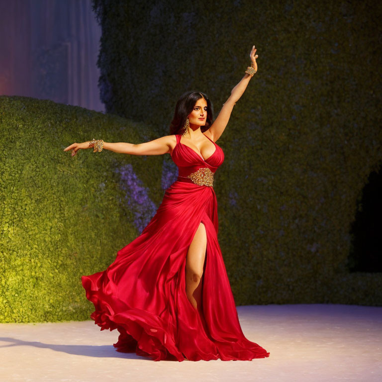 Woman in red dress with high slit strikes elegant dance pose on stage