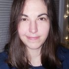 Portrait of Woman with Medium-Length Brunette Hair in Blue Denim Jacket