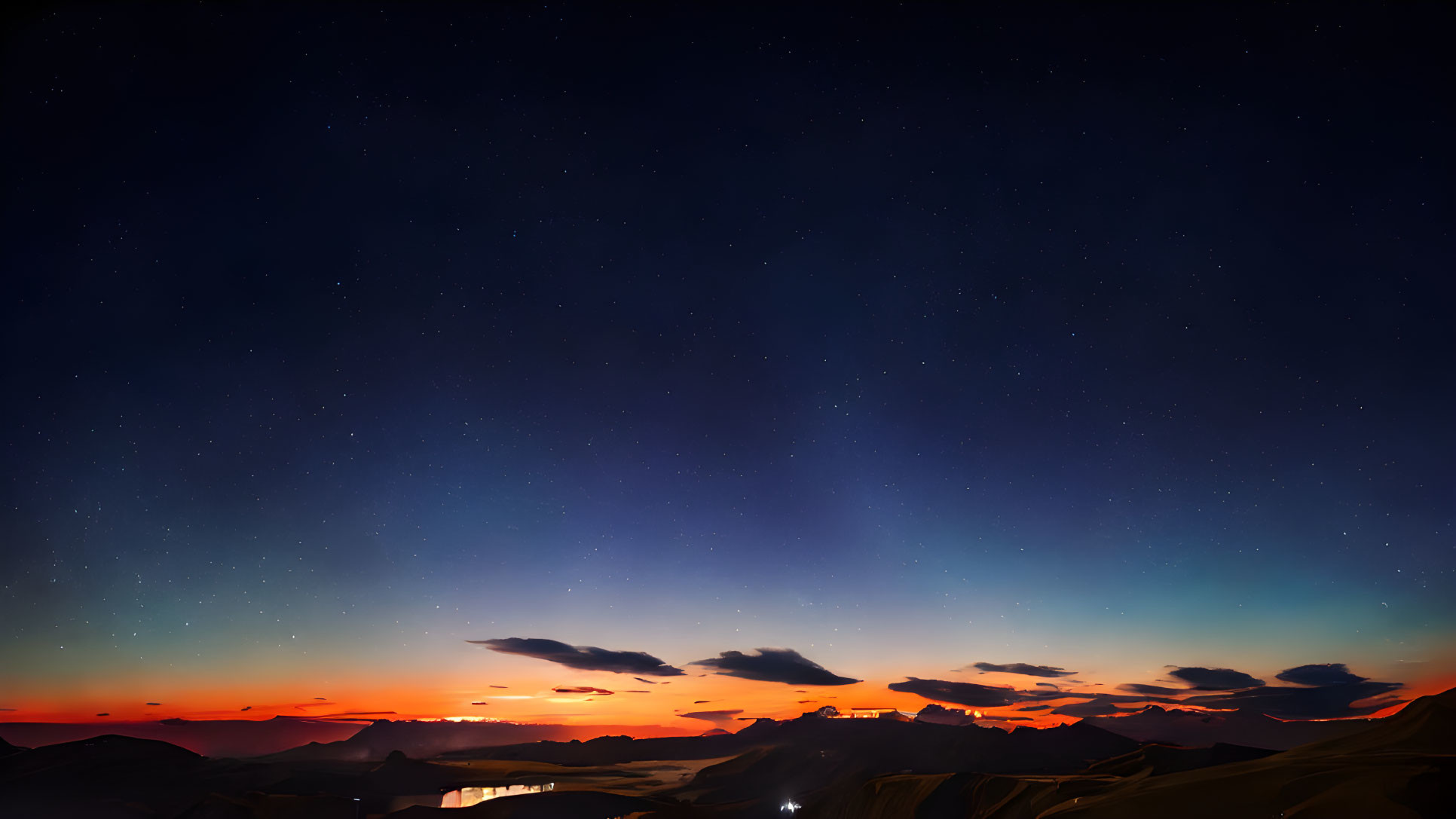 Starry Night Sky over Mountainous Horizon at Sunset