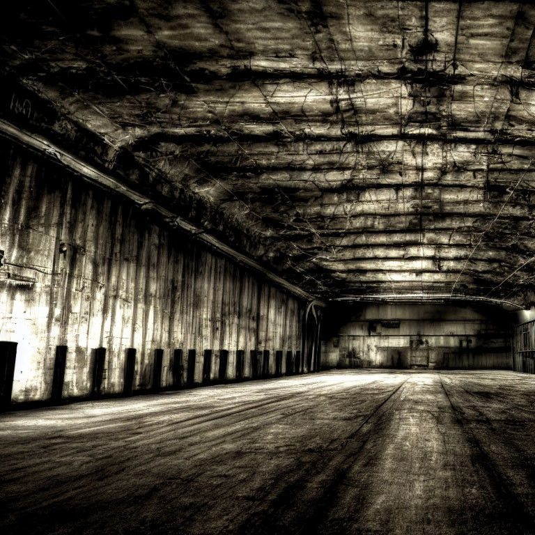 Desolate, gritty warehouse with shadows and textures