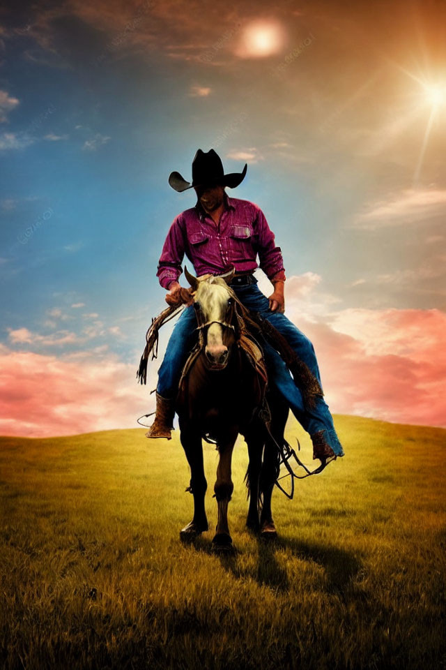 Cowboy riding horse at sunset on grassy hill