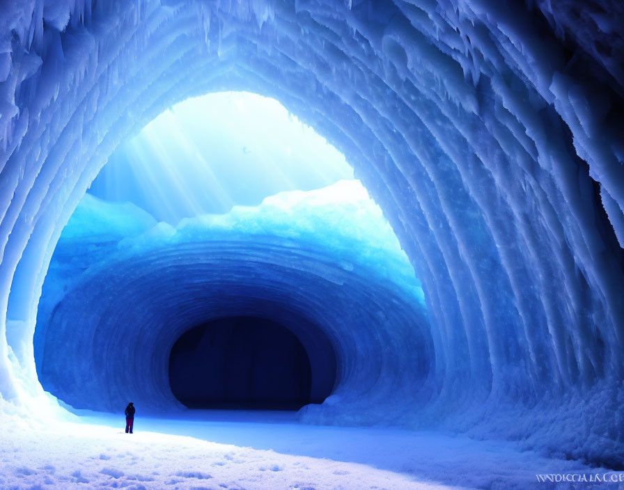 Person in Brilliantly Lit Icy Blue Cave