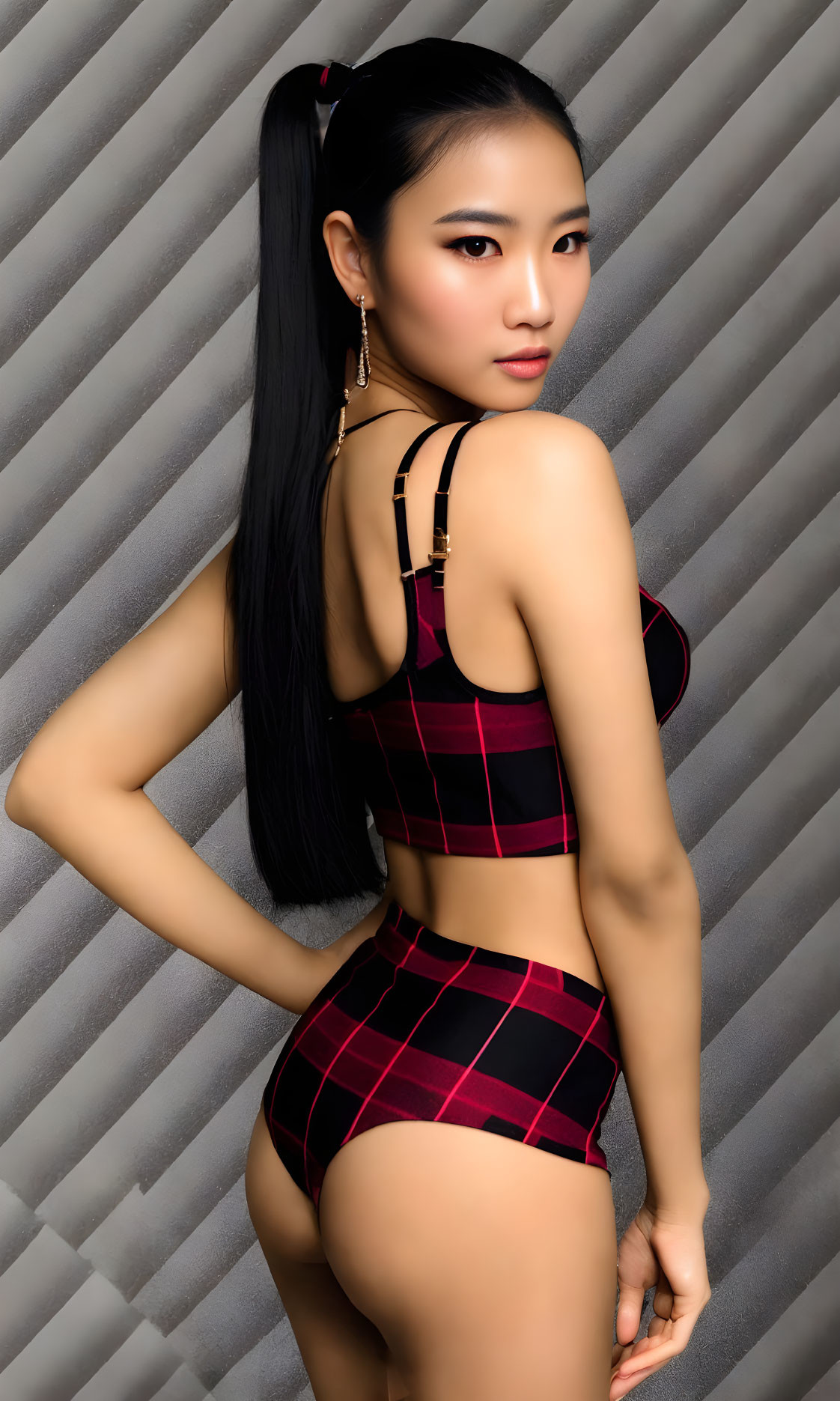 Person in Red and Black Checkered Outfit on Striped Background