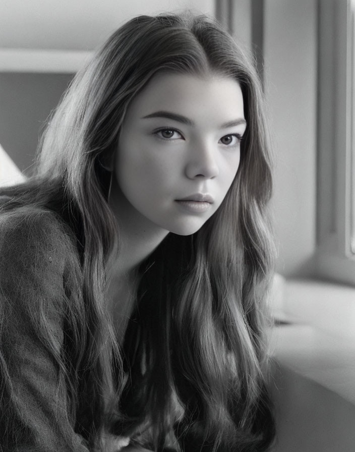 Monochrome portrait of young woman with long hair gazing sideways