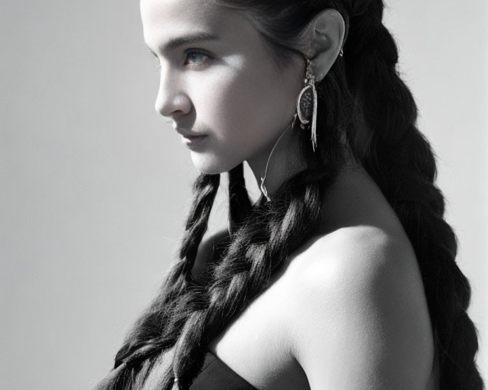 Monochrome portrait of woman with braided hair and earring