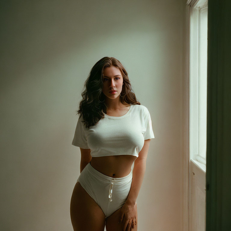 Woman in White Crop Top and Briefs by Window in Soft Daylight