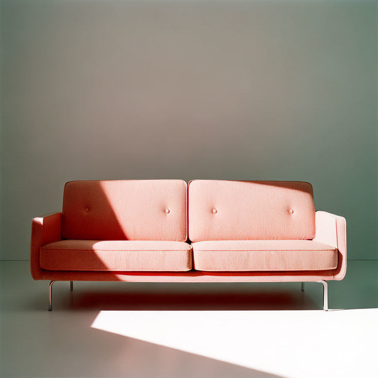 Minimalistic Coral Pink Sofa with Metal Legs on Neutral Background