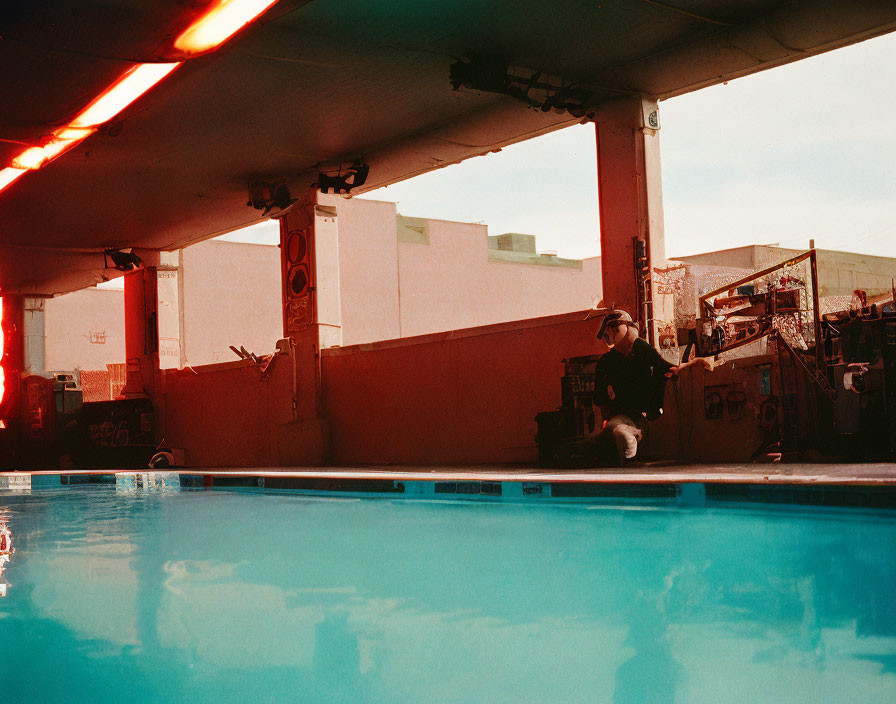 Outdoor Pool Scene with Red Neon Lights and Serene Water