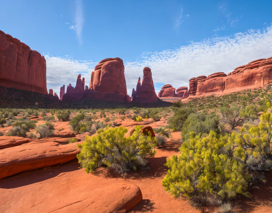 Red Sandstone Formations and Green Shrubs in Desert Landscape