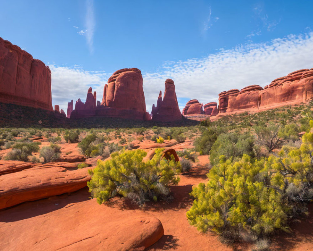 Red Sandstone Formations and Green Shrubs in Desert Landscape