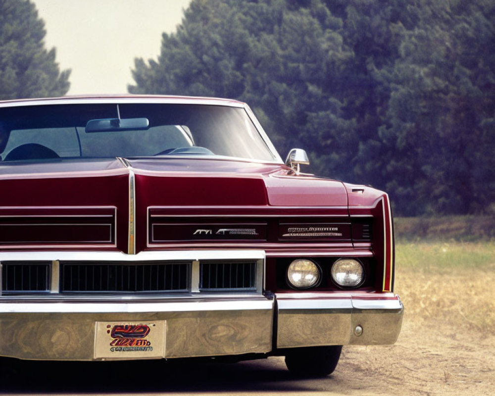 Vintage Red Car with Distinctive Grille and Square Headlights on Dusty Road