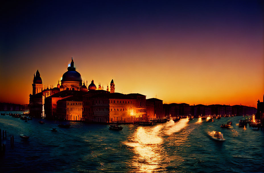 Vibrant sunset over Grand Canal with Santa Maria della Salute silhouette.