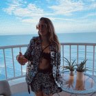 Woman with Long Hair on Balcony Overlooking Sea and Ship