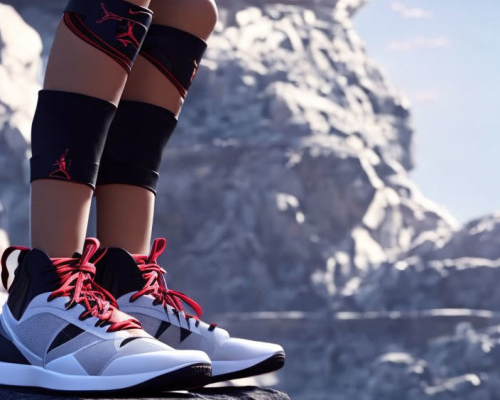 Person in Black Sports Shoes with Red Laces Sitting on Rock with Mountain Background