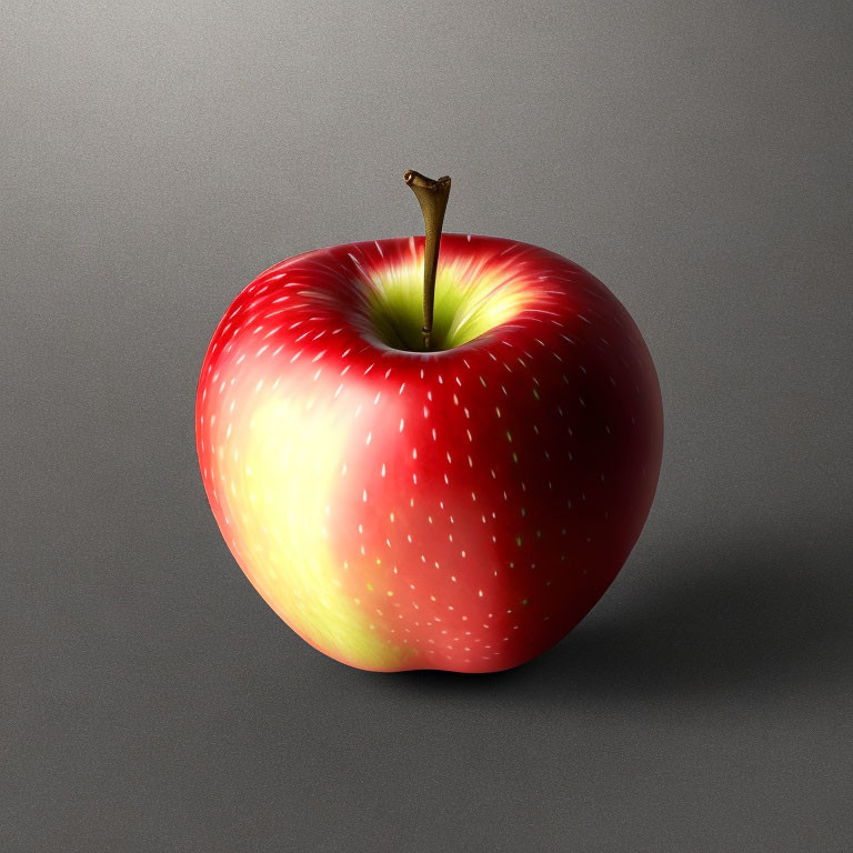 Ripe red apple with yellow blush and brown stem on grey surface