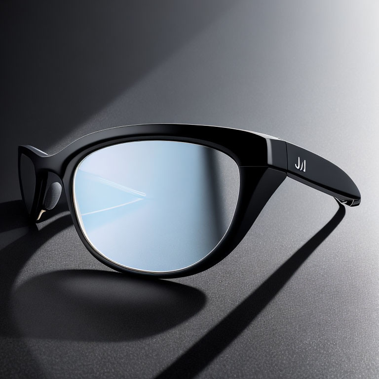 Black-framed sunglass with blue-tinted lens on grey surface