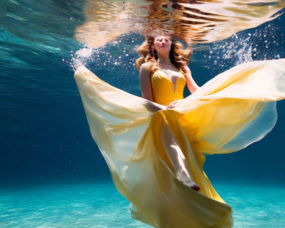 Woman in Yellow Dress Floating Underwater with Sunlight Filtering