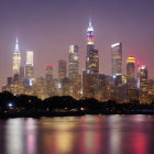 City skyline with illuminated skyscrapers reflected on calm water