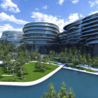 Circular futuristic buildings in green landscape with water features