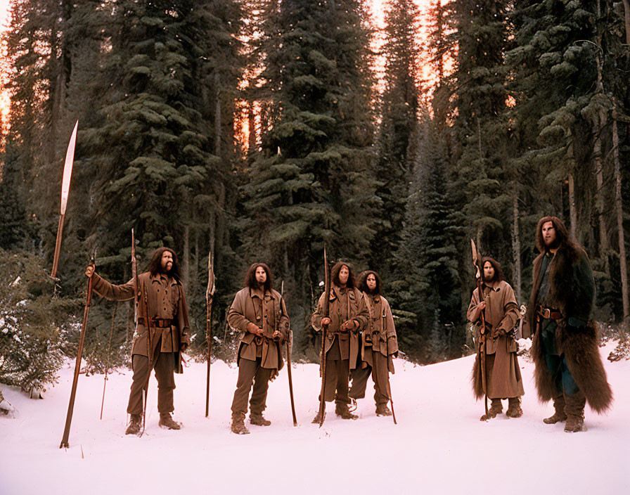 Indigenous people in traditional clothing with bows and spears in snowy forest at dusk