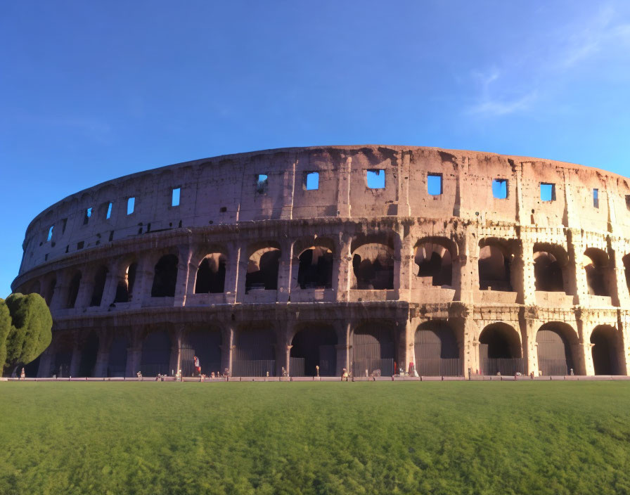 Ancient Colosseum facade at sunset with visitors under clear blue sky