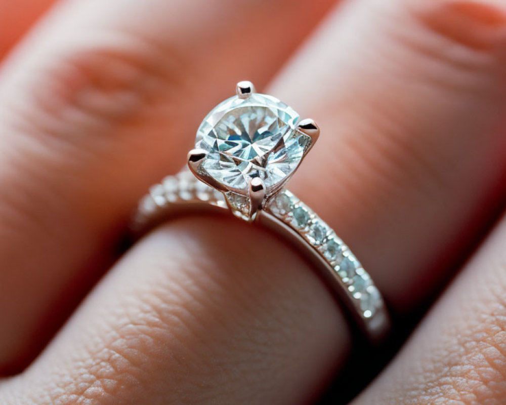 Detailed view of diamond engagement ring with central stone and smaller diamonds on band