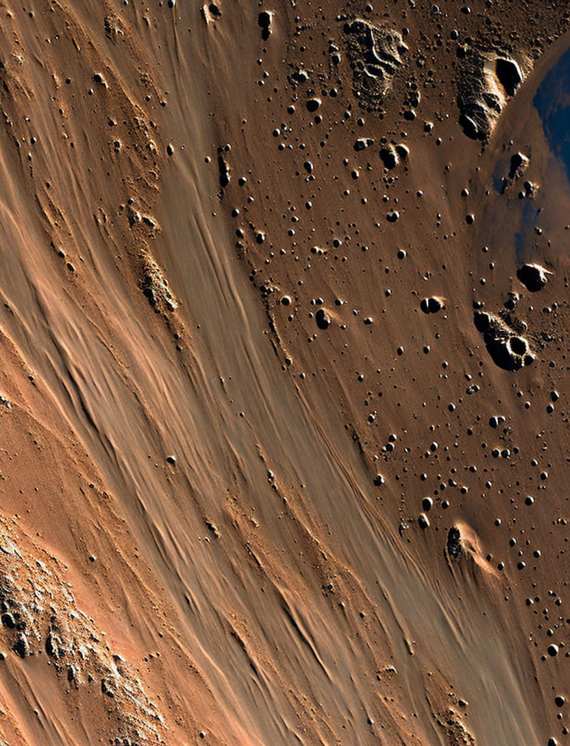 Barren Mars-like terrain with sandy slopes and rocky outcrops