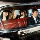 Man in Black Suit Resembling Spock in Luxury Car