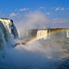 Scenic landscape with waterfalls, rainbow, and bubbles