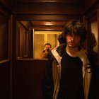 Man in Suit in Dimly Lit Corridor with Shadows