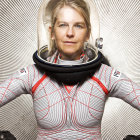 Red-haired person in silver spacesuit on metallic background