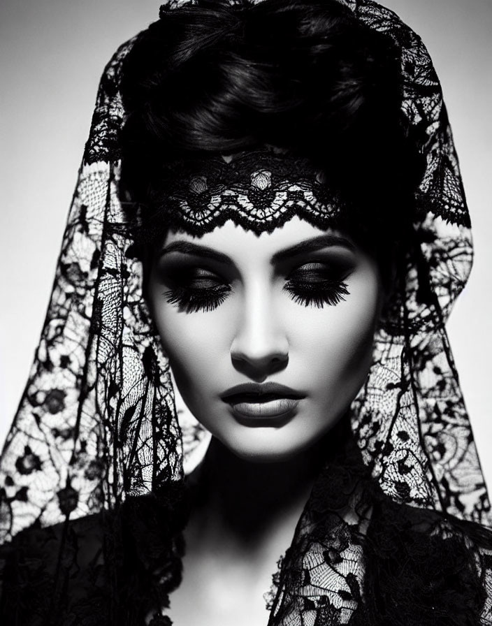 Monochrome portrait of woman with dramatic makeup and lace veil