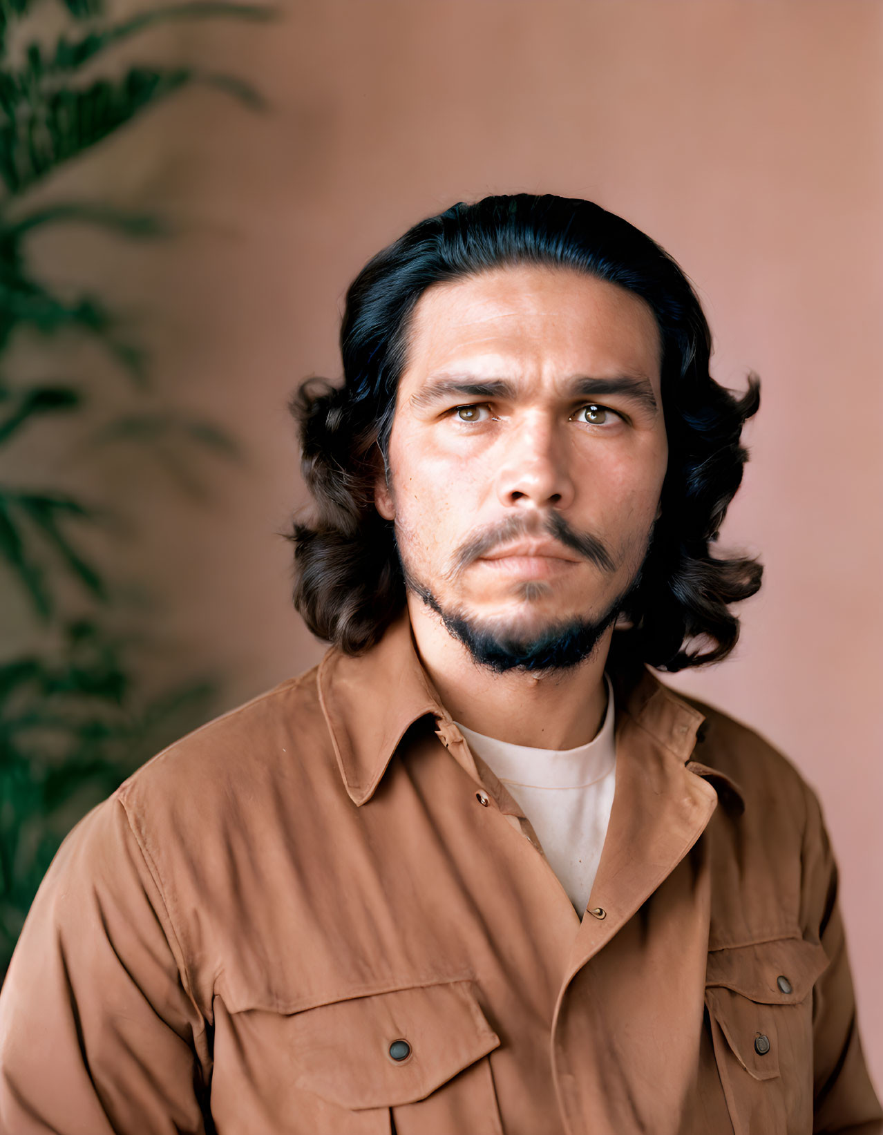 Man with Wavy Hair and Mustache in Brown Shirt on Pink Background