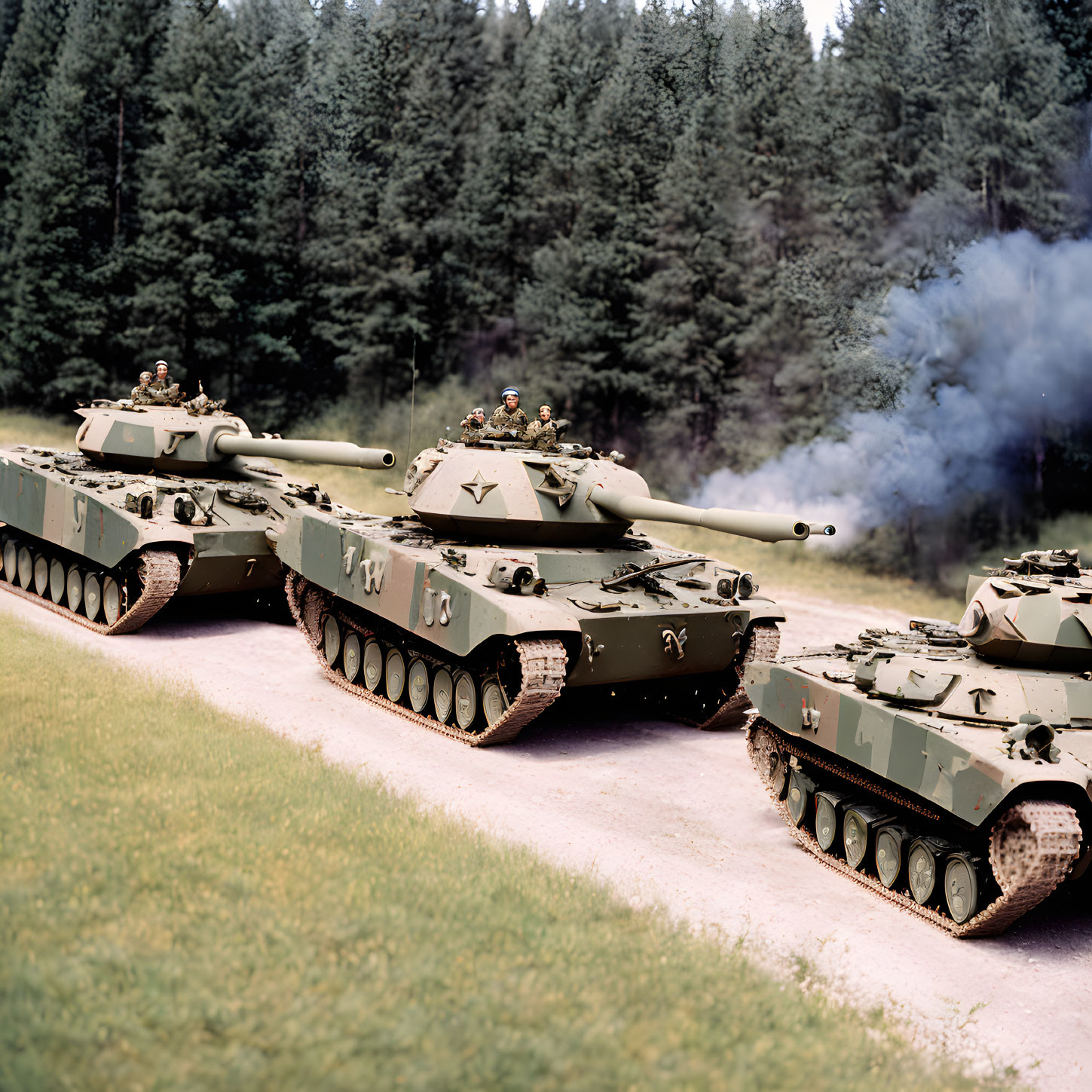 Camouflaged Military Tanks Advancing in Forested Area