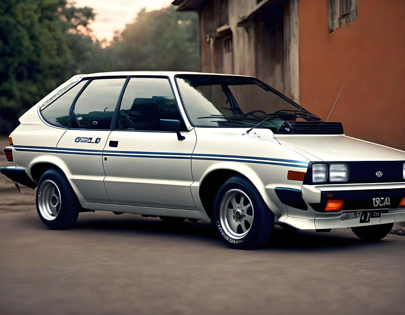 Vintage white Ford Escort Mk3 hatchback with black trim parked at dusk