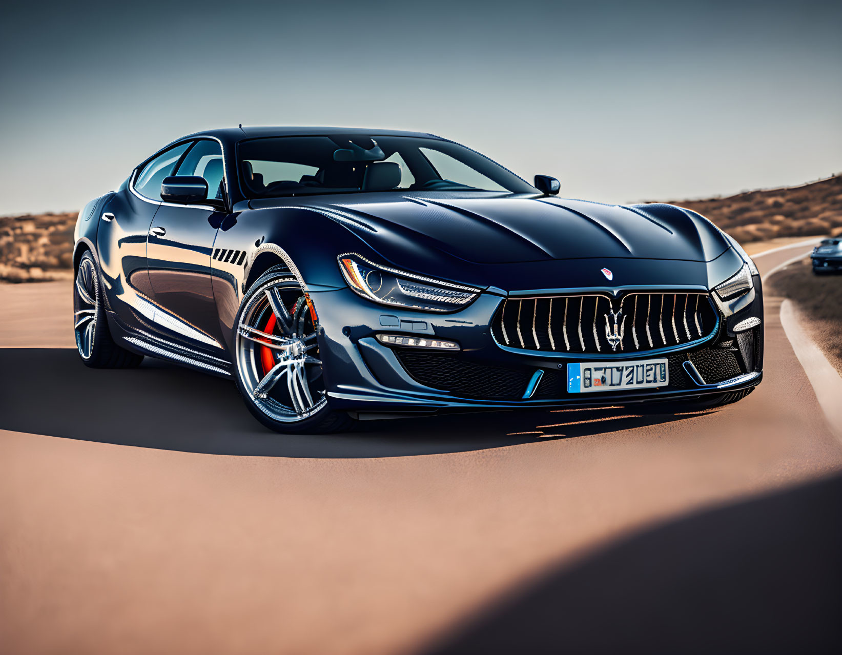 Blue Maserati with Trident Logo on Desert Road Displaying Dynamic Stance