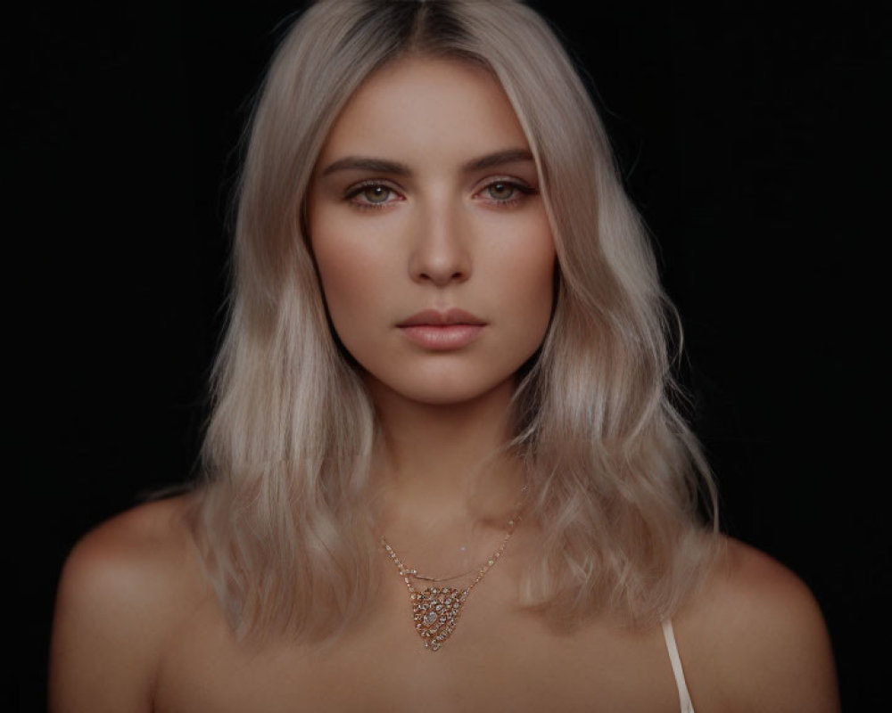 Blonde woman portrait with subtle makeup and golden necklace