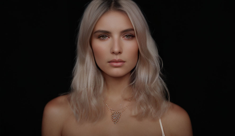 Blonde woman portrait with subtle makeup and golden necklace