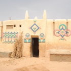 Cream Facade, Blue Mosaic Details, Rounded Arches: Middle Eastern Style Building