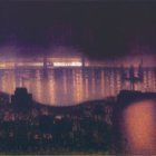 Nighttime seascape with lightning over distant horizon and illuminated old city by calm waters.