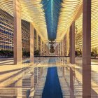 Symmetrical golden arches in futuristic atrium with intricate patterns