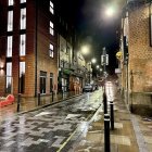 Moonlit Street Scene with Cobblestones and Illuminated Buildings