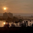 Sunset landscape with castle mirrored in lake