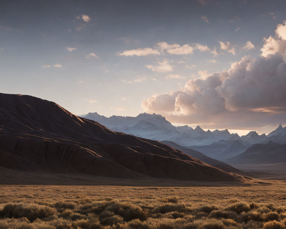 Tranquil sunset landscape with rolling hills and snowy peaks